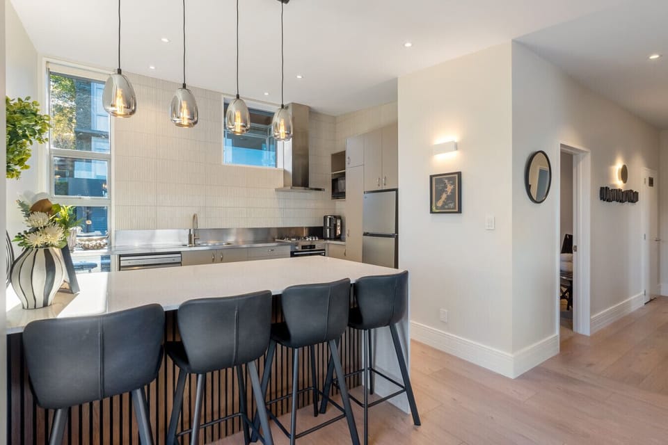 Leather bar stools at the island - the dining space for the apartment