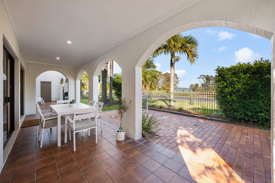 Tiled patio with dining set and scenic views.