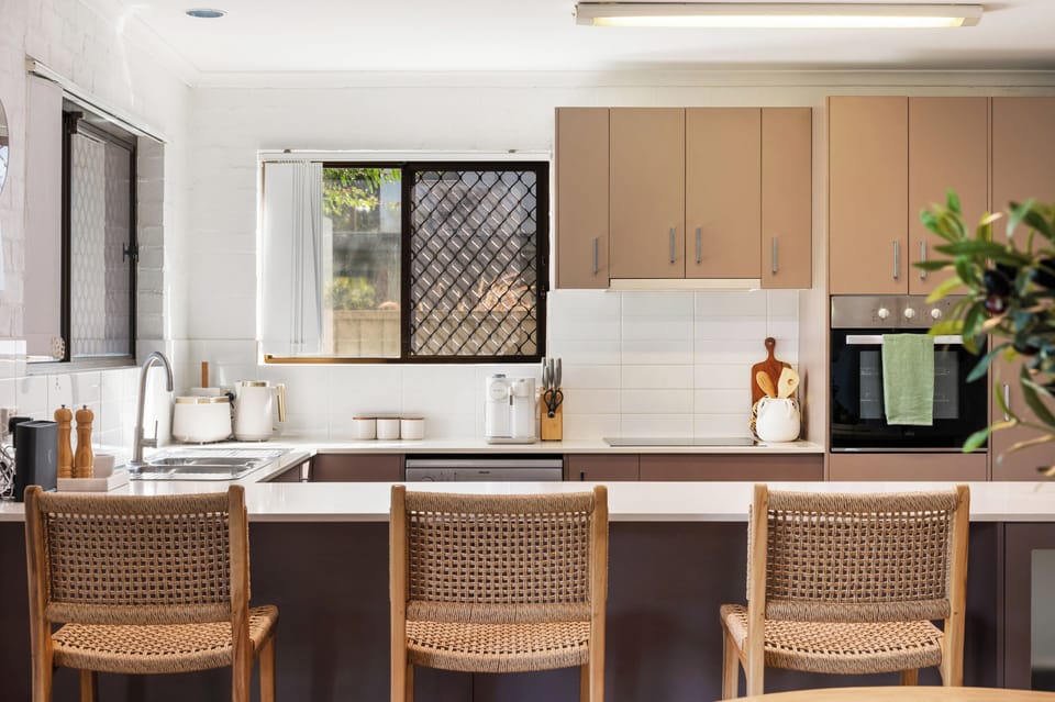 Modern kitchen with breakfast bar and built oven.