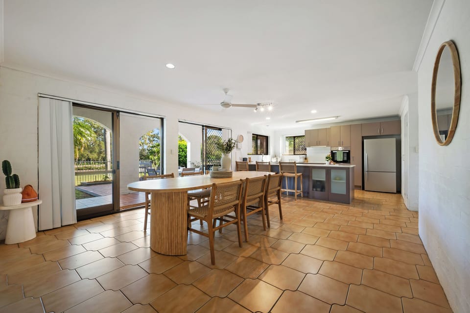 Spacious dining room with full kitchen and patio.