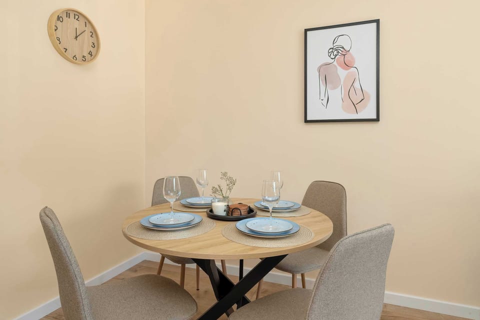 A dining corner with a round table and upholstered chairs. Simple decorations create a pleasant atmosphere.