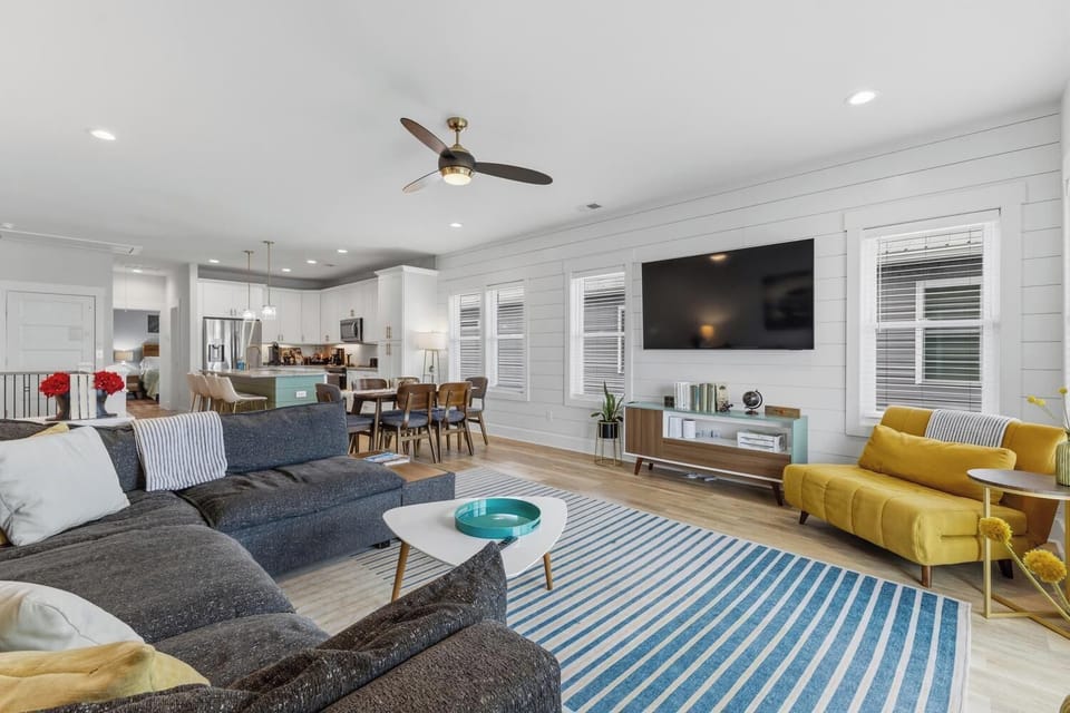 Sink into plush seating and unwind in your bright, open-concept living space, where coastal-inspired colors and modern comfort create the perfect home base for your getaway.