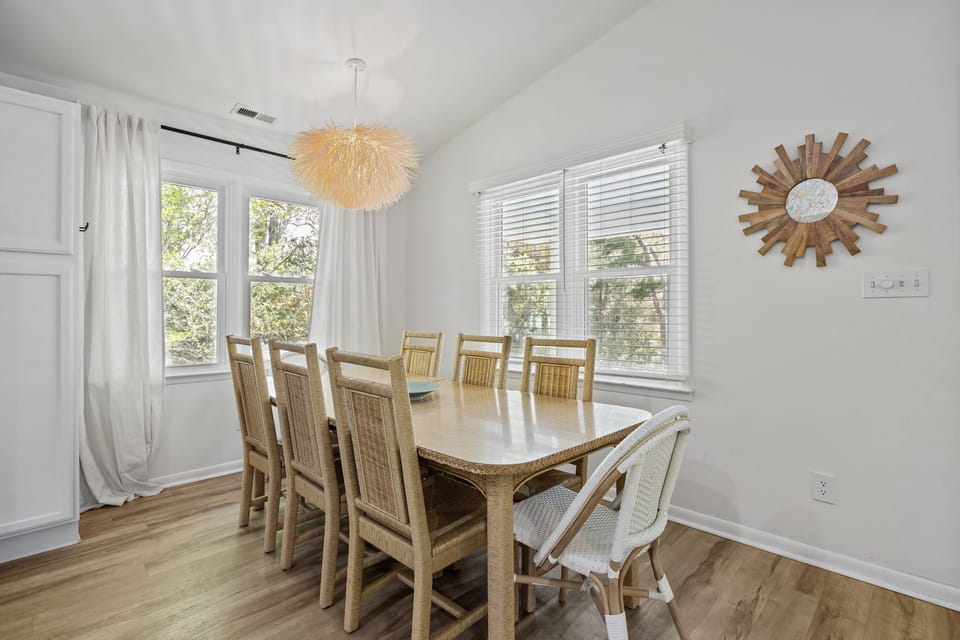 Gather around your spacious dining table where warm wood tones meet bright natural light for memorable meals together.