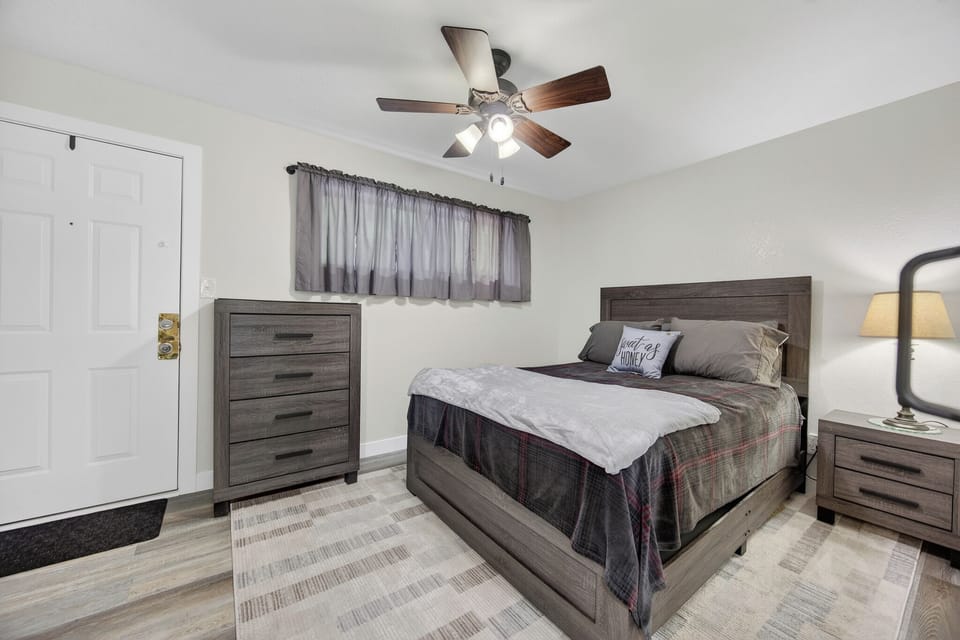 Unwind in your private bedroom with a plush bed, ample storage, and a gentle ceiling fan to keep you comfortable after a day exploring the area.