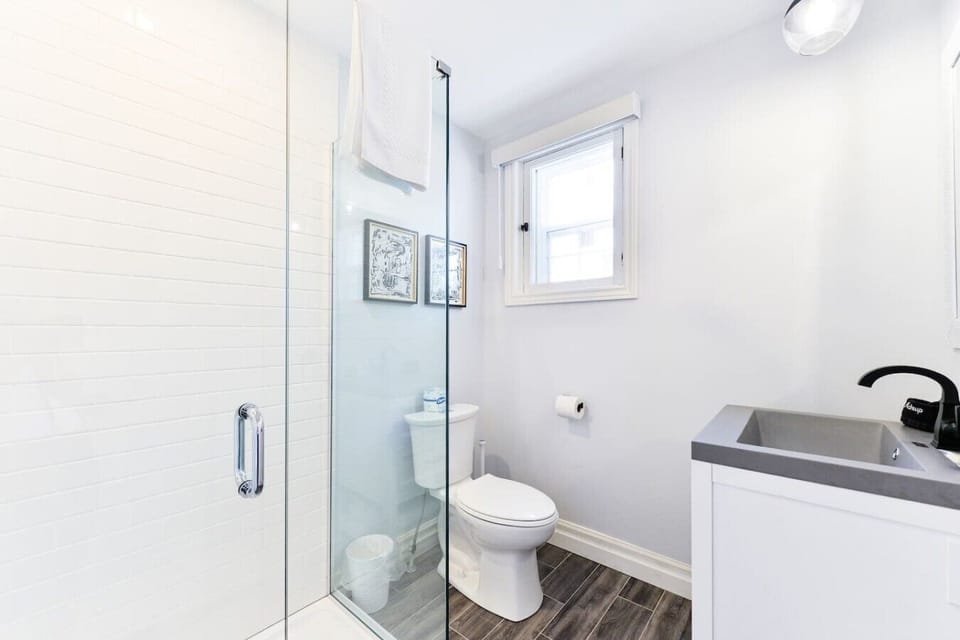 Refresh and recharge in the modern bathroom, featuring a walk-in shower, plush towels, and complimentary amenities for a comfortable stay.