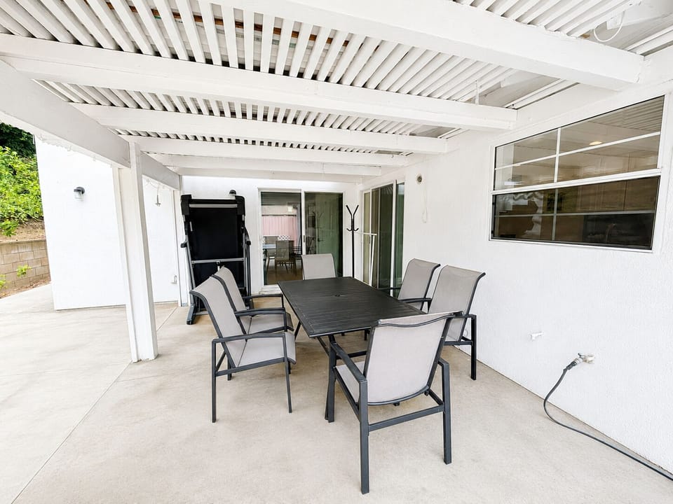 Shared covered patio with outdoor dining area and seating space