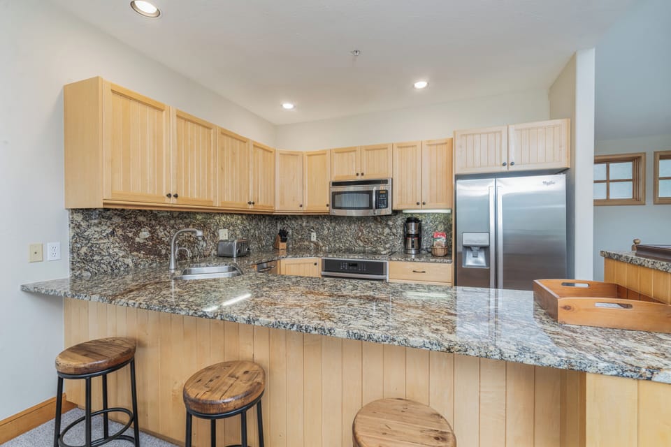 Your fully equipped kitchen features granite counters, stainless appliances, and a breakfast bar—perfect for preparing meals and gathering with loved ones.