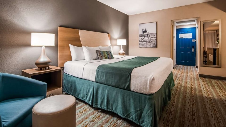 Recharge in a cozy king bed with hotel-style comfort.