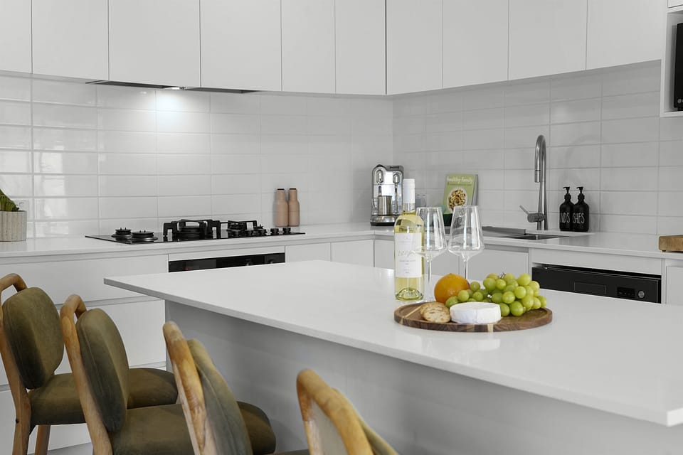 Gather around the sleek kitchen island—perfect for morning coffee, casual meals, or evening drinks.