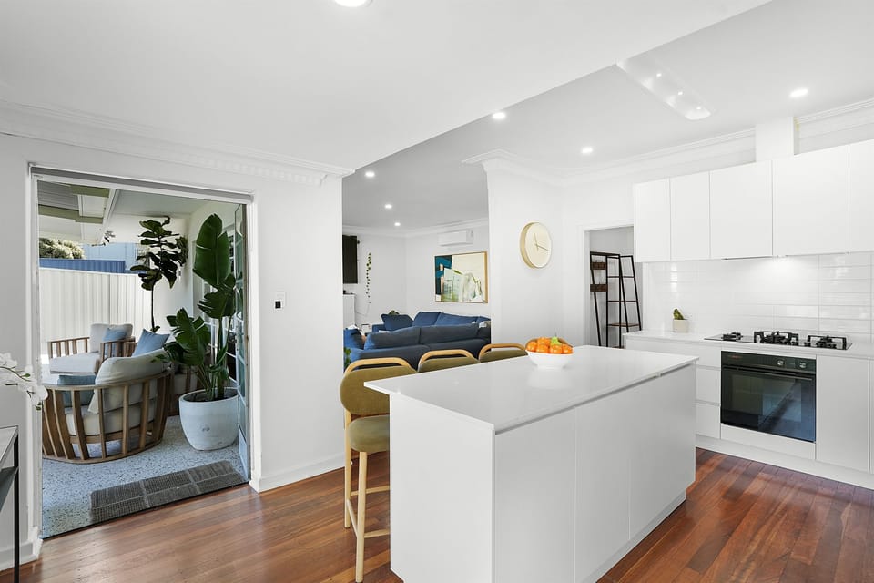 The open-plan kitchen flows effortlessly into the living and alfresco spaces, creating a welcoming heart of the home.