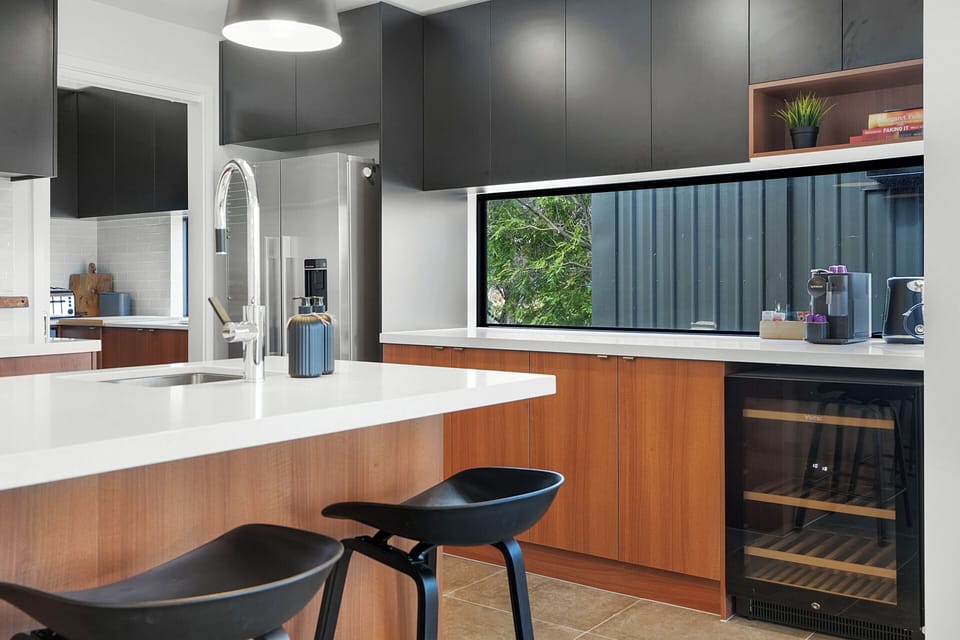 Stylish breakfast bar and wine fridge for relaxed mornings or evening drinks.