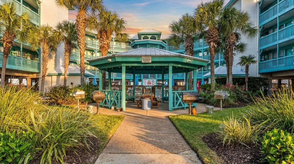 Tropical courtyard with gazebo, grills, and resort-style coastal charm