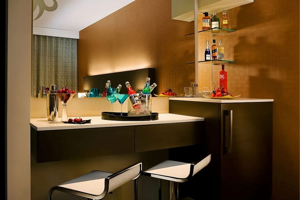 Sip crafted cocktails at your chic in-room bar nook.