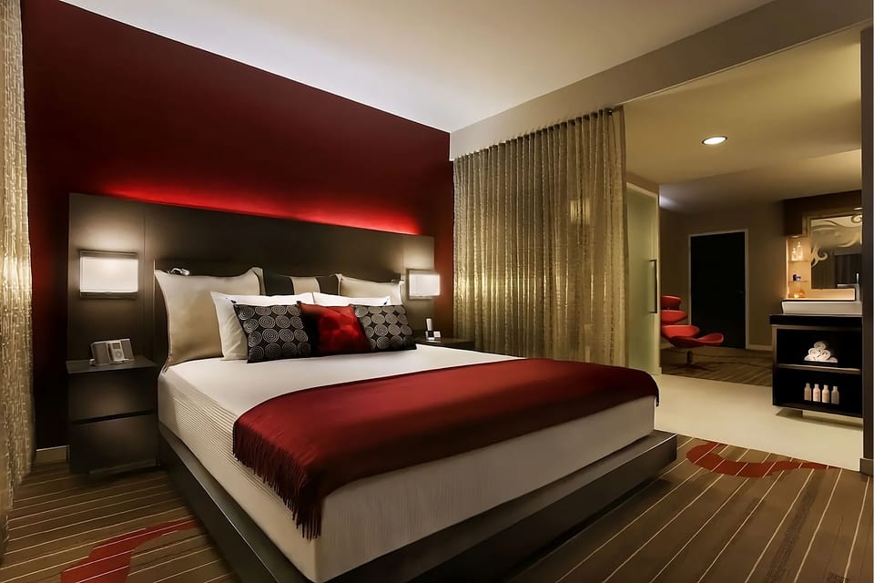 Recharge in a stylish king room with rich, cozy tones.