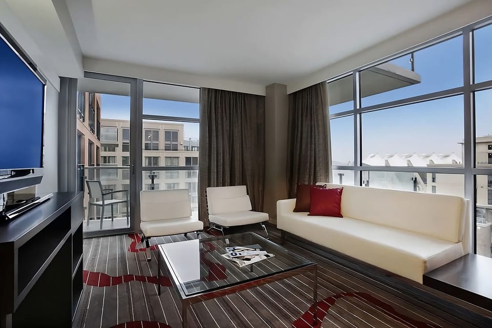 Lounge by expansive windows and savor the city energy.