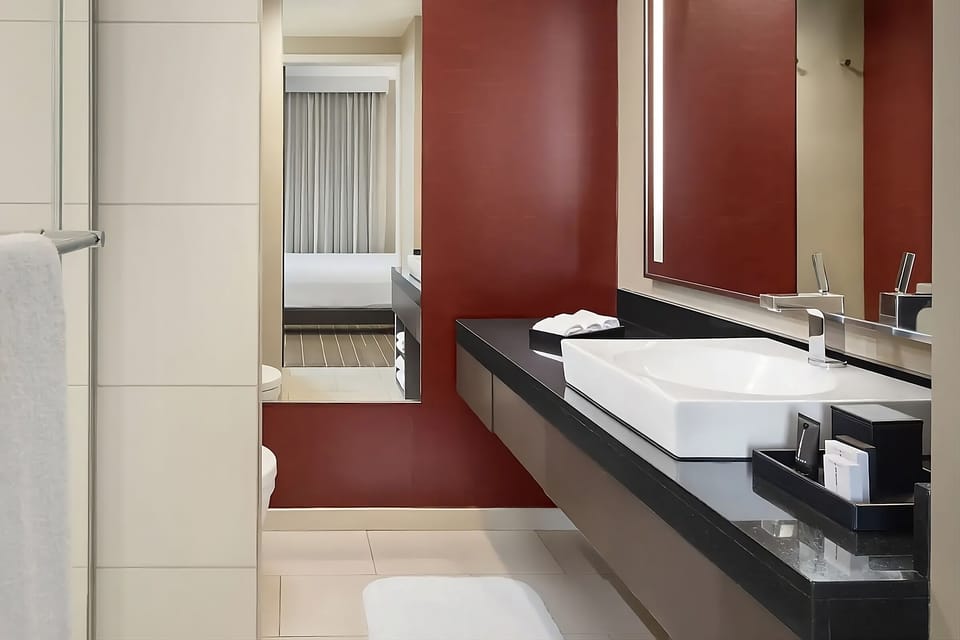 Freshen up in a modern bath with expansive counter space.