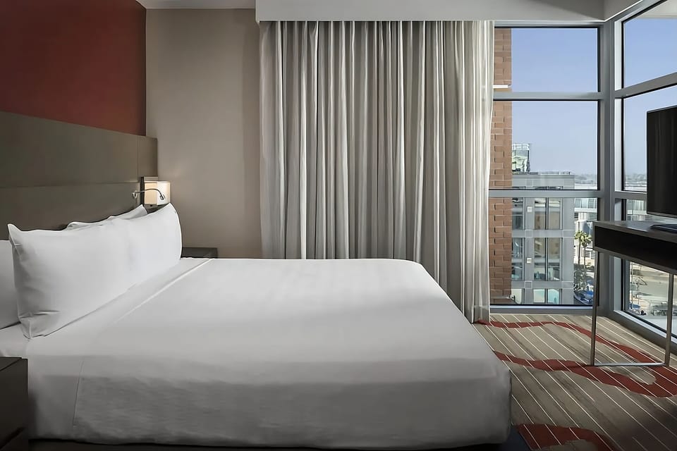Wake up to city views beside crisp, cloud-soft linens.