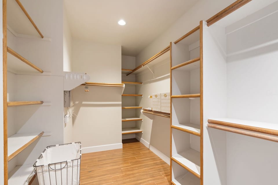 Retreat to a spacious primary suite with a King bed, cozy fireplace sitting area, walk-in closet, and private en-suite bathroom for a relaxing stay.
