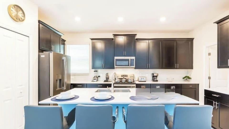 Spacious kitchen with granite counter tops, stainless appliances and fully stocked with all cooking and dining necessities. Open floor plan connects to the living and dining rooms.


