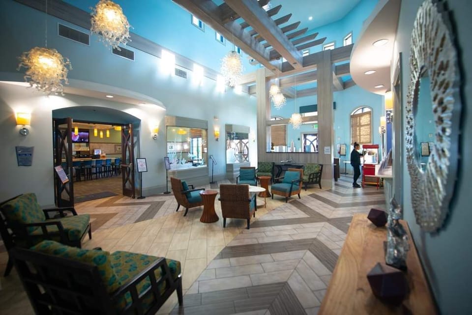 Lobby: Step into vibrant elegance with stunning decor, inviting seating, and a lively atmosphere! Lobby and entrance to restaurant at The Oasis clubhouse

