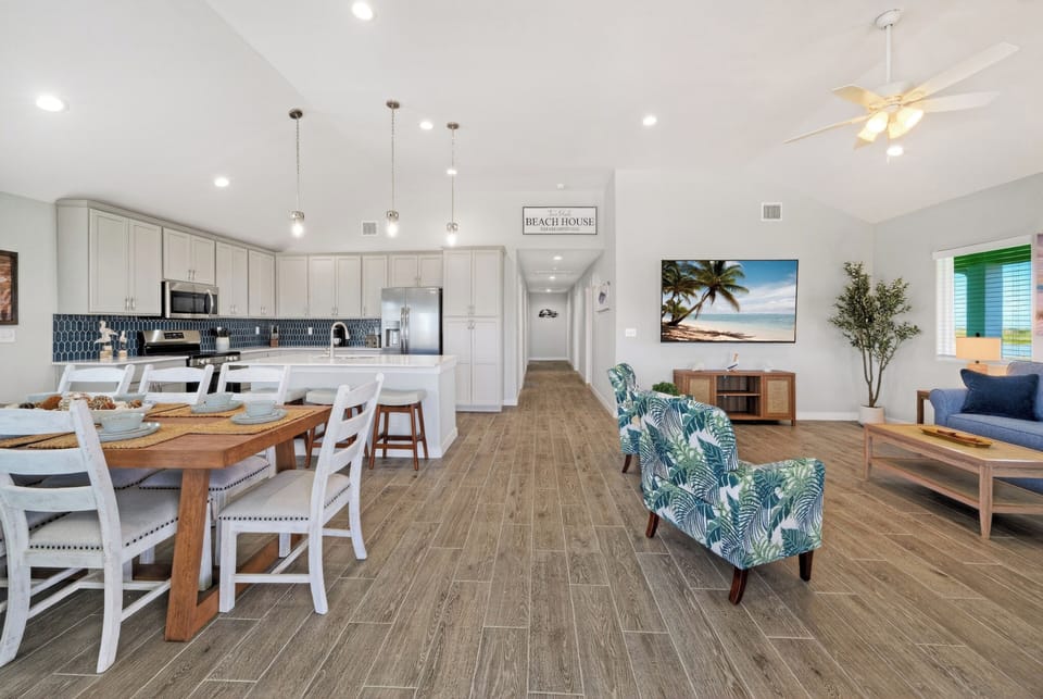 Expansive main-level view highlighting seamless wood-look plank flooring throughout the open living space.