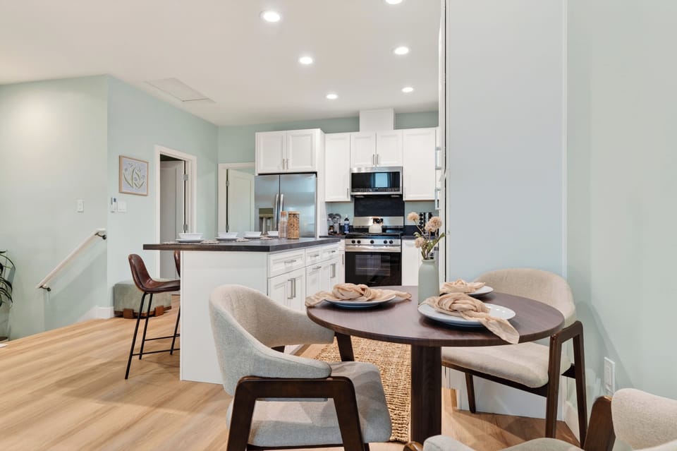Cozy dining nook beside the bright modern kitchen, perfect for easy meals between beach outings.