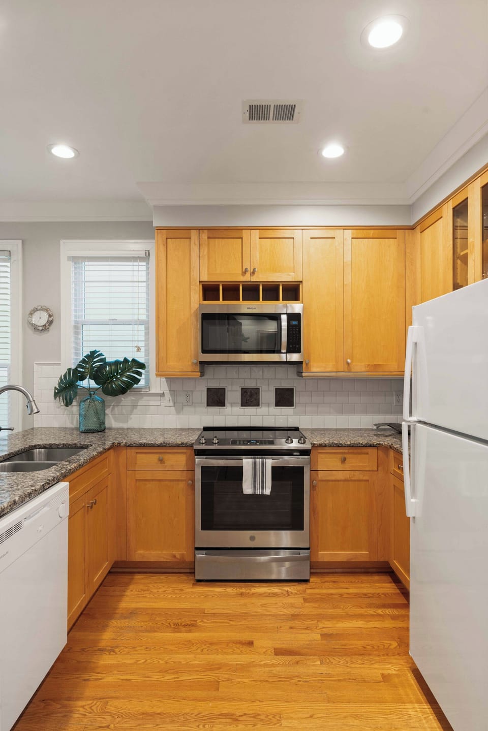 Fully equipped kitchen with modern stainless steel appliances and ample counter space for meal prep.