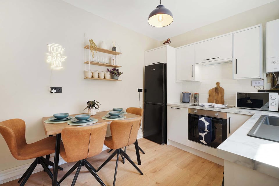 Gather around the dining table for relaxed breakfasts, evening meals, or time spent together during your stay. Positioned alongside the kitchen, the space offers a practical and comfortable setting for everyday dining.