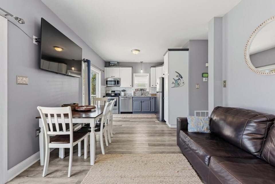 Your open-concept living space blends kitchen, dining, and lounging effortlessly, with modern appliances, cozy seating, and stylish finishes welcoming you home after a day of exploring.