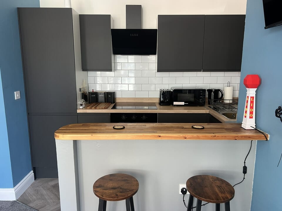Kitchen with fridge, freezer, oven, hobs, kettle, microwave and toaster