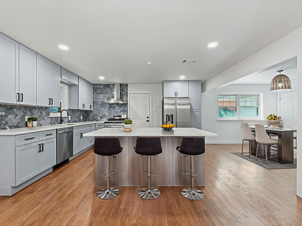 Your dream kitchen awaits with sleek white cabinetry, granite countertops, and a spacious island perfect for cooking adventures.