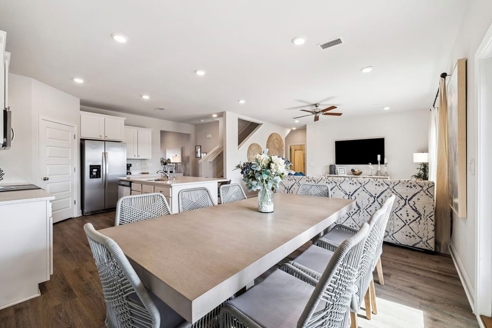 Gather around your spacious dining table where memorable meals and conversations unfold in this bright, modern open-concept space.