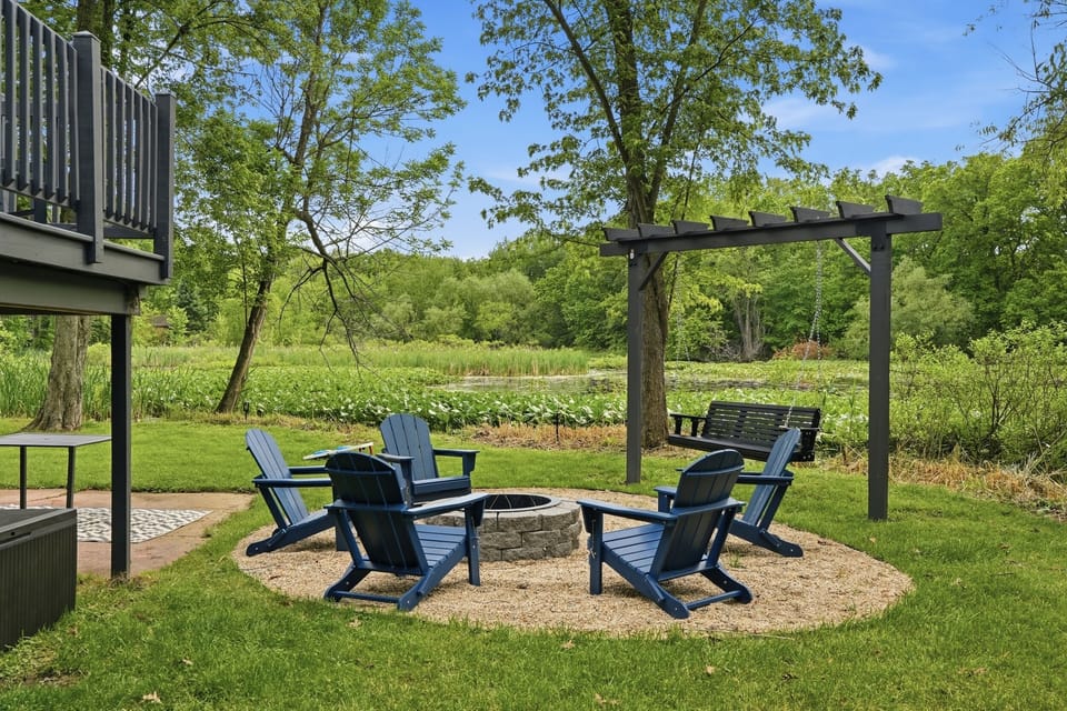 ⭐ Fire pit circle surrounded by Adirondack chairs with the wetland view — evenings here are unforgettable