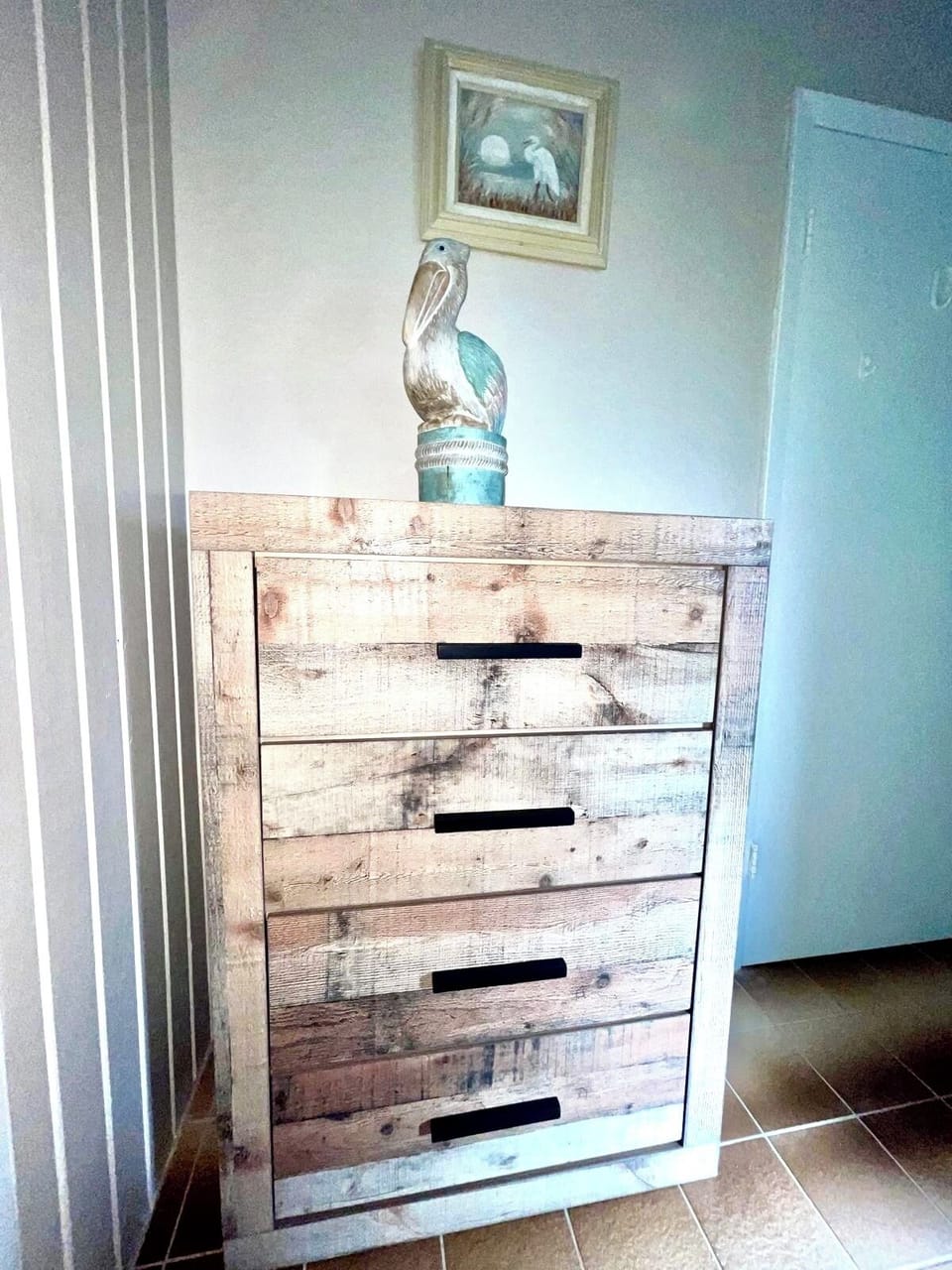 Primary bedroom’s dresser accompanies a closet.