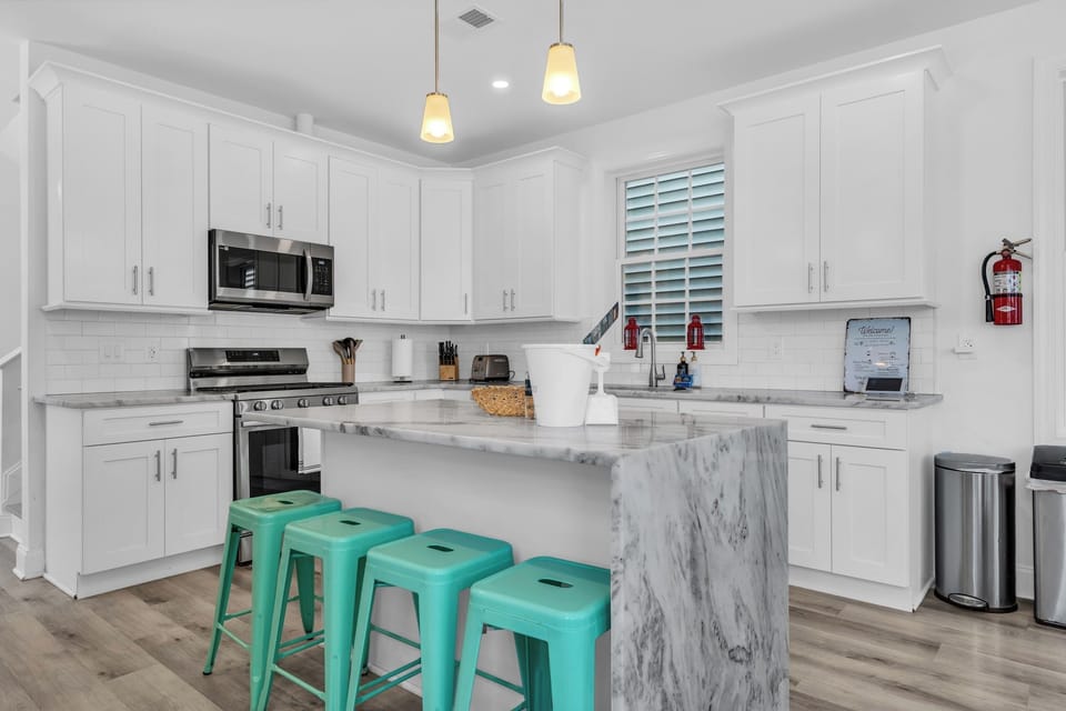 Bright modern kitchen with waterfall island and cheerful bar seating