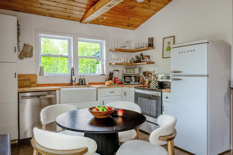 Farmhouse kitchen and dining at Inkwood Reserve — fully equipped with a cozy dining nook and forest views in this Catskills cabin, Livingston Manor, NY