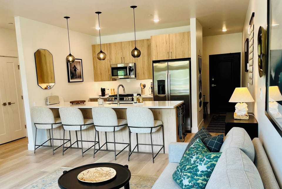 View of kitchen and entry from the couch area.