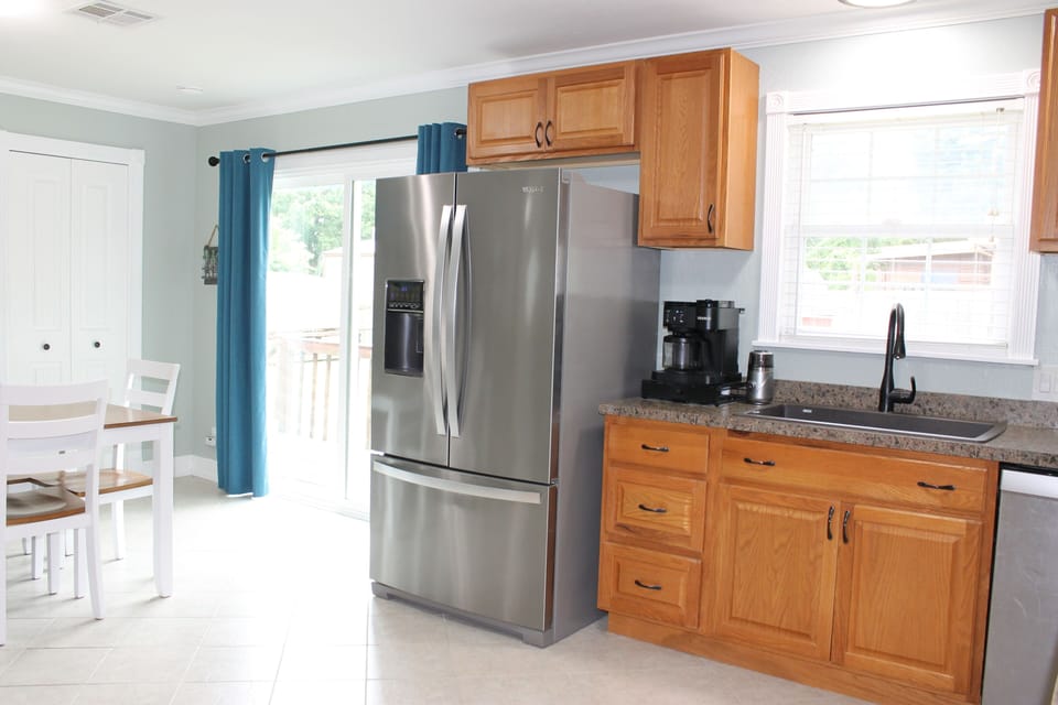 Farmhouse sink and french door refrigerator with bottom freezer. Natural light 