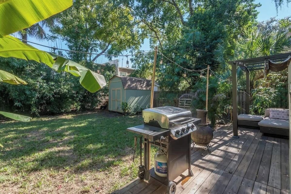 Outdoor Oasis: BBQ grill and lounge spot surrounded by lush greenery for ultimate relaxation!