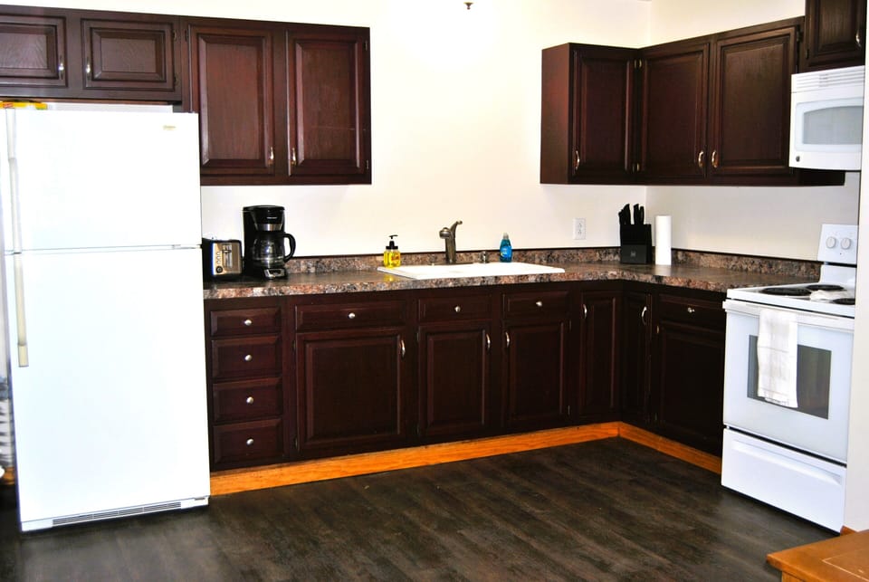 Full kitchen including:microwave,  coffee pot, full range, refrigerator. 