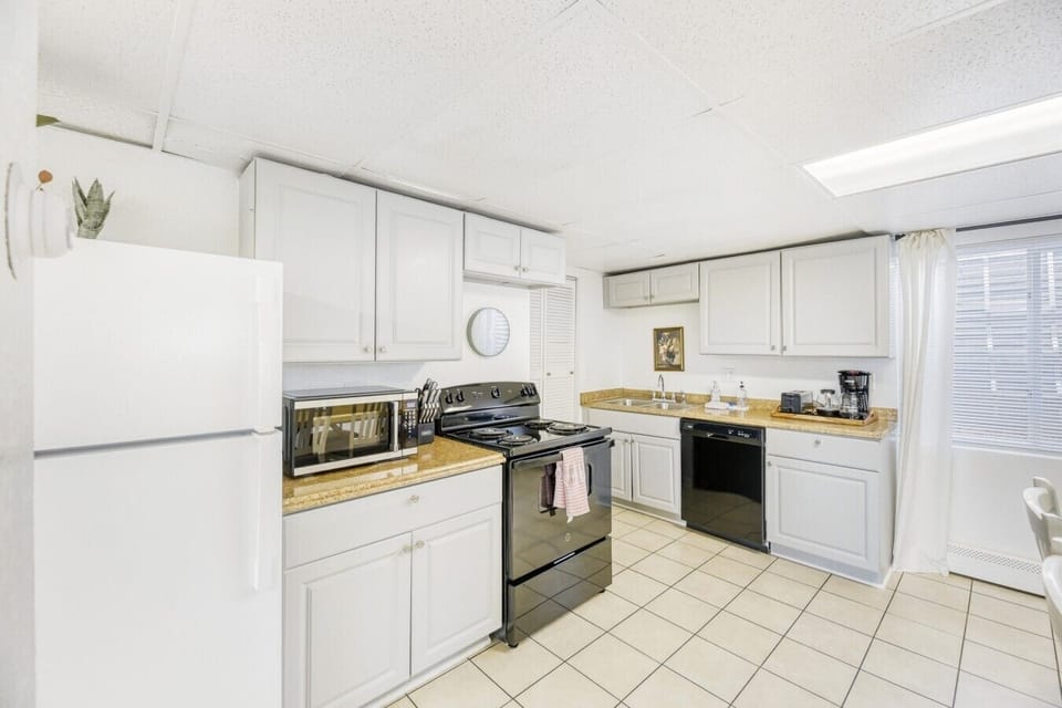 Fridge, oven, microwave, toaster, dishwasher, coffee maker, and teapot provided.