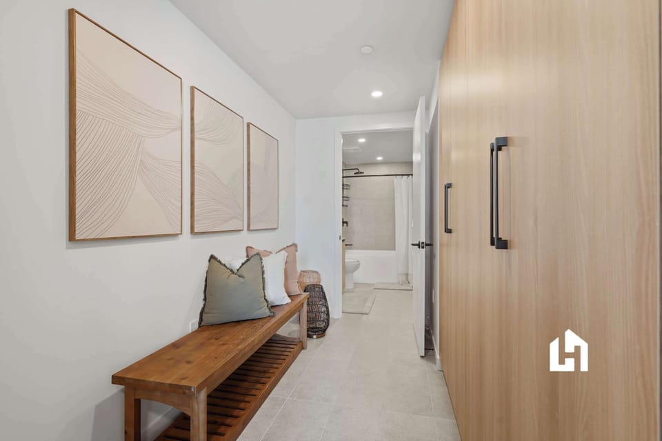 Spacious entryway with warm wood accents and artwork