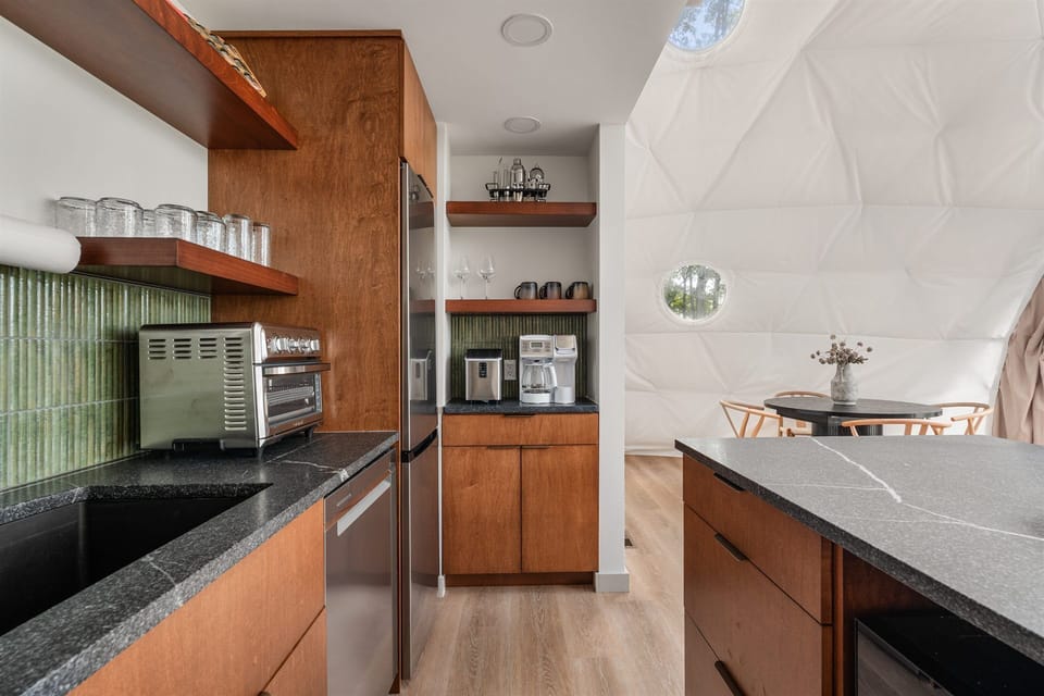 Modern kitchenette with coffee bar and unique light-filled dome dining area