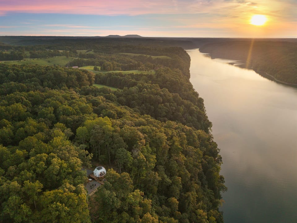 Secluded dome retreat with breathtaking river views at sunset