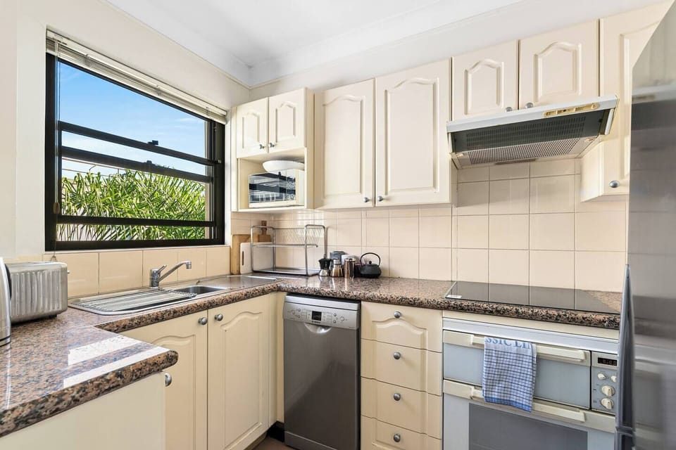The practical kitchen includes essential appliances, such as an oven, stove, dishwasher, microwave, and everything needed for easy meals during your stay.