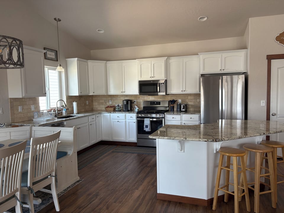 Our kitchen feature a large center island and barstools for casual dining, food prep and serving, cards, and much more. There is an outlet on the end for small appliances. Two of the counter outlets also feature USB ports for charging.