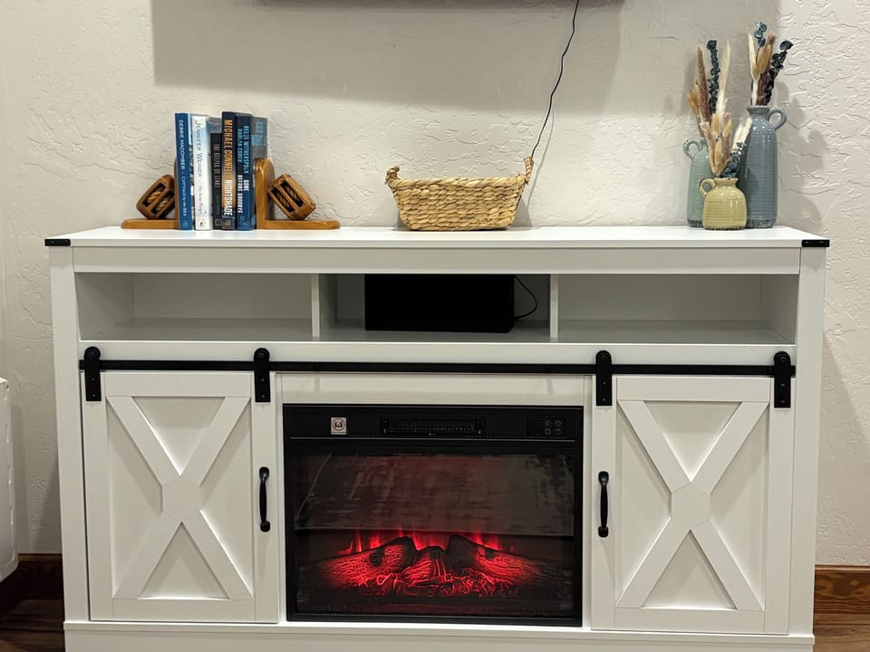 The electric fireplace provides ambiance as well as warmth during cooler months.