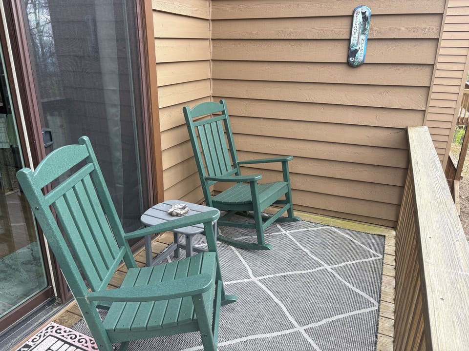 Private balcony with rocking chairs. Seasonal mountain and wooded views.