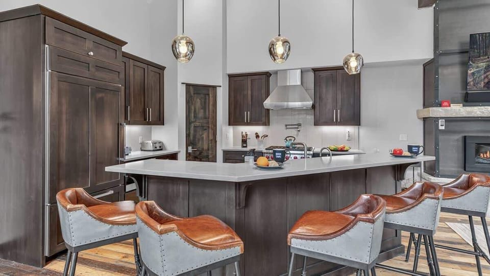 Kitchen: Drip coffee maker, Nespresso, Crockpot, blender, Sub-Zero refrigerator, Wolf oven, Wolf range, Wolf stovetop, Wolf microwave, Asko dishwasher, kitchen island, bar stools, main floor