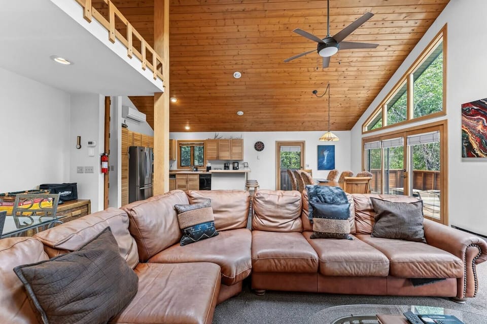 Open concept living space with soaring ceilings and huge windows